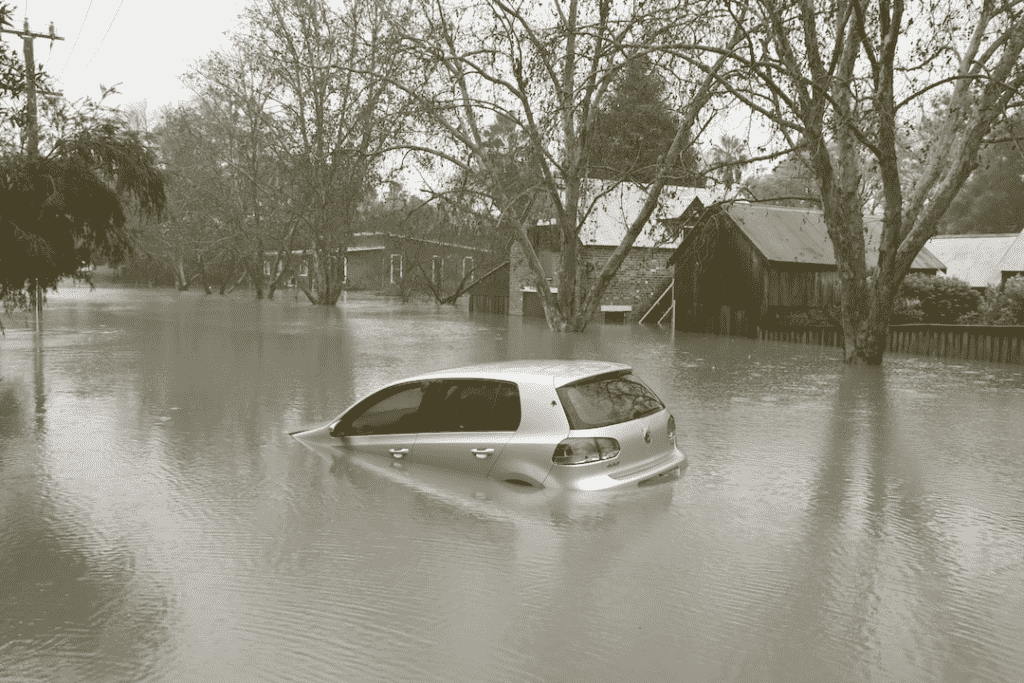Car in flooded residential street, home preparedness for flood