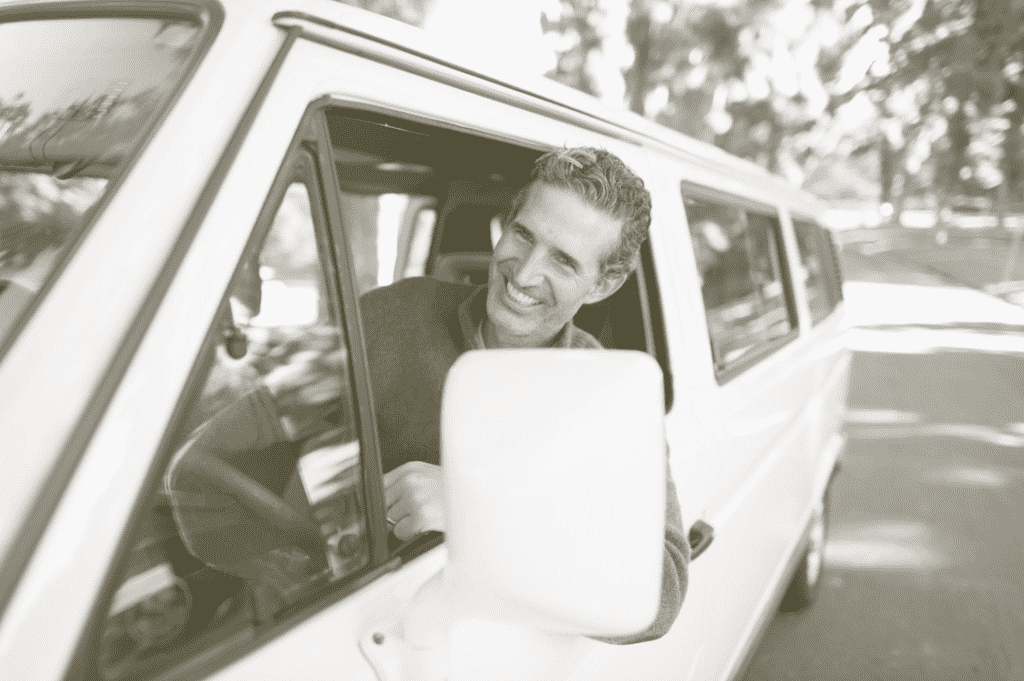 smug neighbor grinning from car