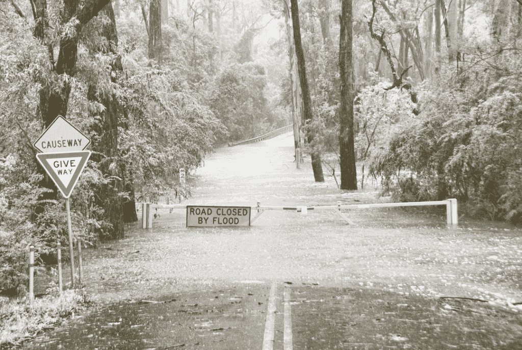 road way closed by flood sign