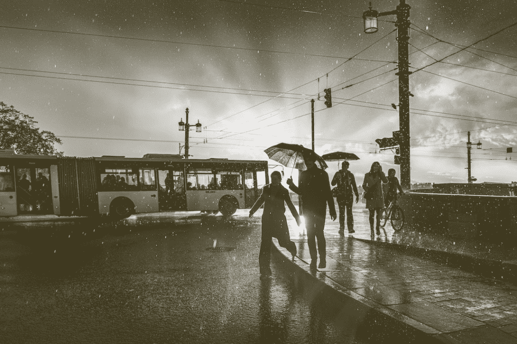 Flooded street with people with umbrellas