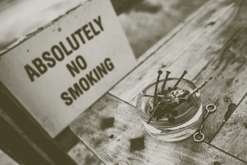 No smoking sign with ashtray with nails