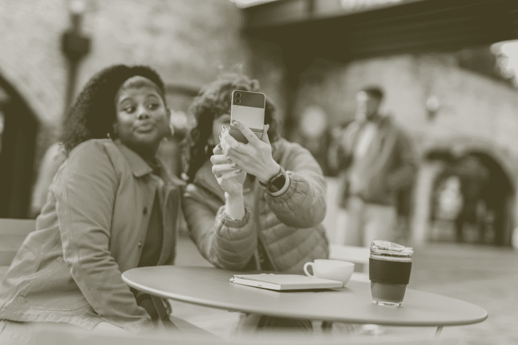Two friends taking a selfie at a coffee shop