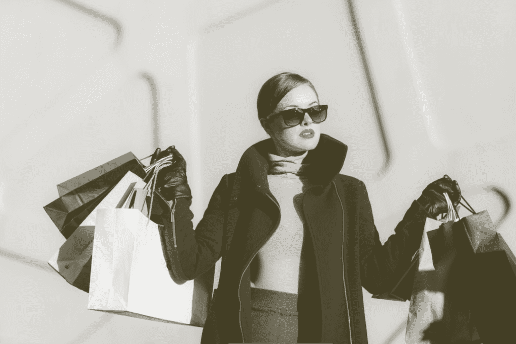 Fashionable shopaholic woman with many shopping bags