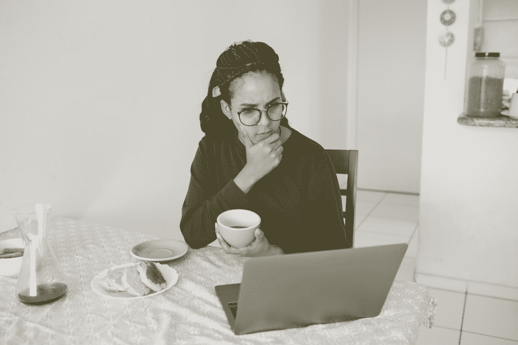 Woman thinking at her laptop