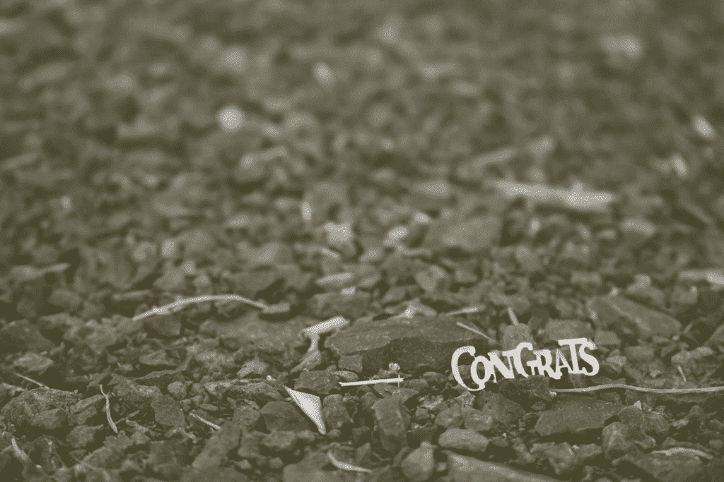 small piece of confetti spelling out "Congrats"