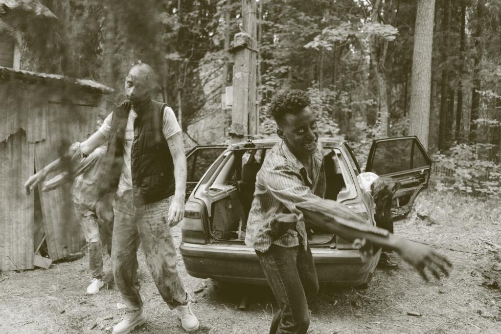 two zombies in front of a car