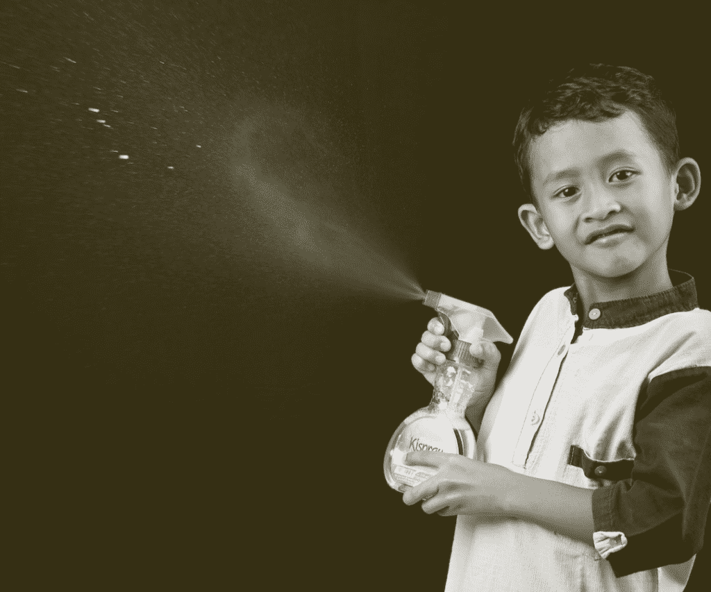 kid with spray bottle