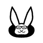 Bunny rabbit peaking out of a hole wearing glasses